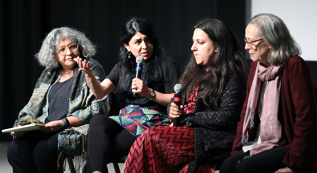 A group of people converse onstage