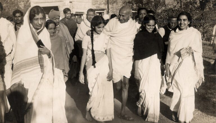 black and white image of a group of people dressed in traditional Indian garb.