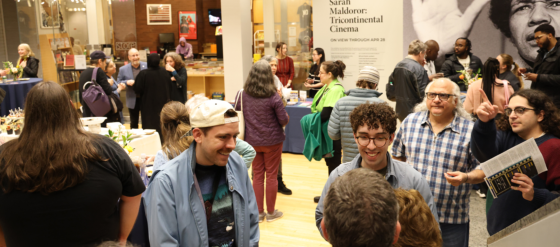 Cinema Revival 2024 attendees mingle around food and drink in the Wexner Center lower lobby.