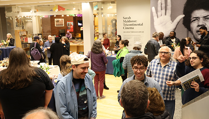 Cinema Revival 2024 attendees mingle around food and drink in the Wexner Center lower lobby.